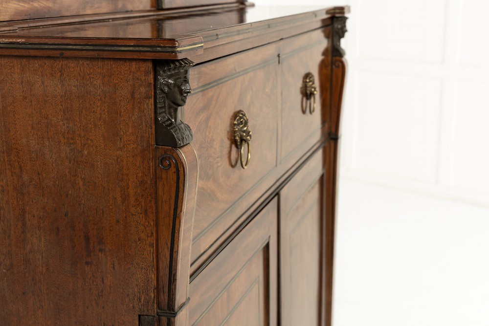 A 19th-century Regency mahogany secretaire bookcase featuring upper glazed doors with diamond astragal bars and a scroll pediment above drawer and cupboard base. View XVI