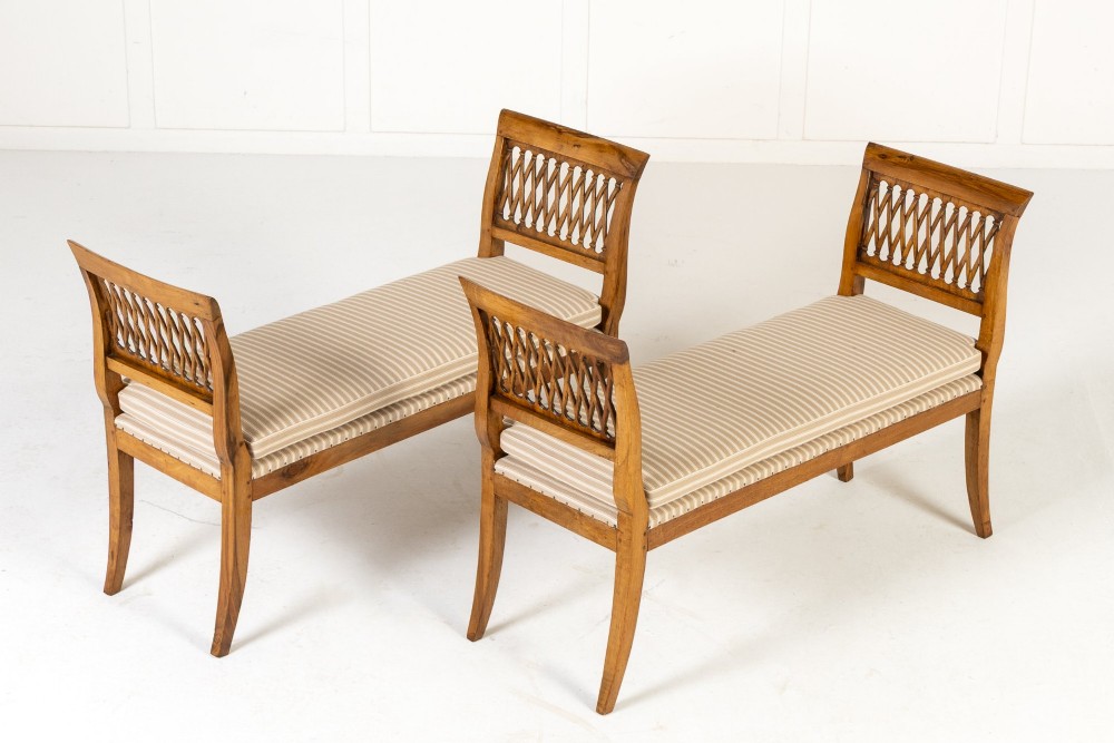 A pair of 19th-century French walnut window seats with carved lattice ends and striped upholstered cushions. View II