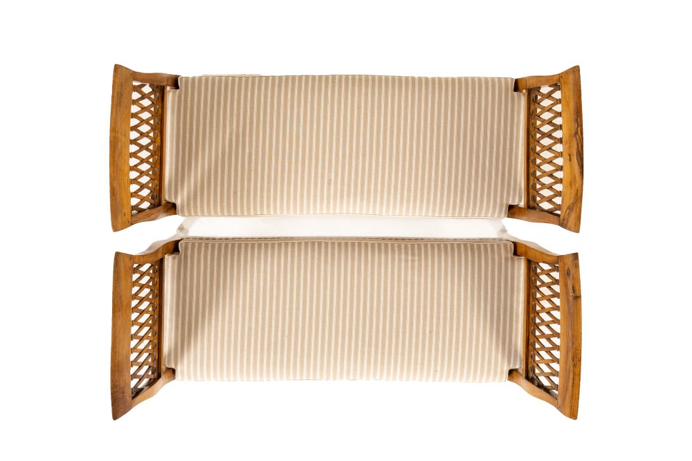 A pair of 19th-century French walnut window seats with carved lattice ends and striped upholstered cushions. View IV