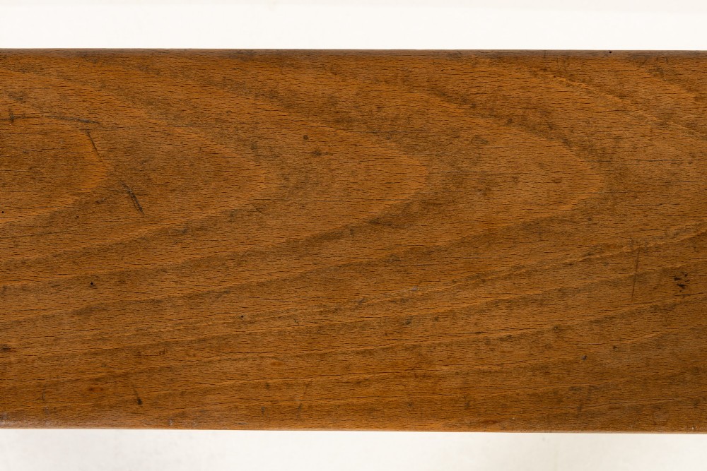 A pair of 19th-century French backless wooden hall benches featuring shaped trestle supports and visible joinery. View VII