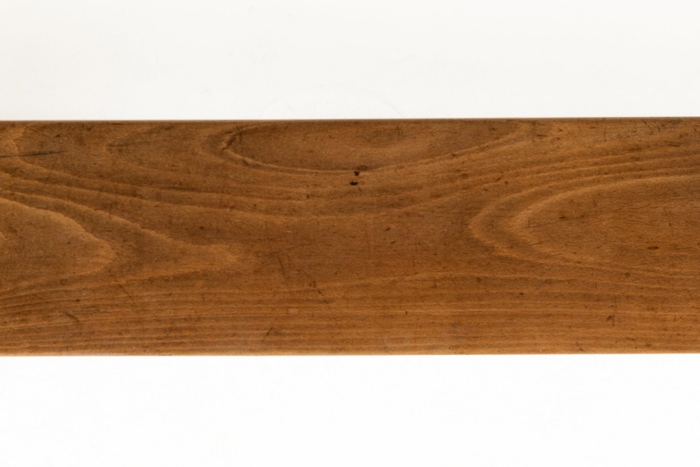 A pair of 19th-century French backless wooden hall benches featuring shaped trestle supports and visible joinery. View IX
