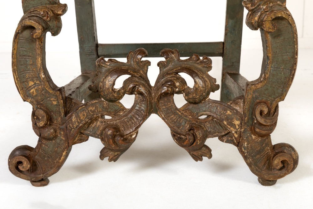 A pair of 17th-century Italian side chairs featuring tall backs upholstered in natural brown hessian, resting on elaborately carved scrollwork legs with a green painted finish. View III