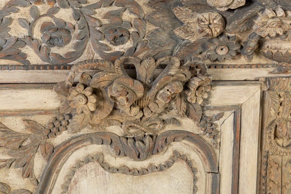An eighteenth-century carved French painted oak armoire featuring two doors with ornate floral mouldings and short cabriole feet. View III