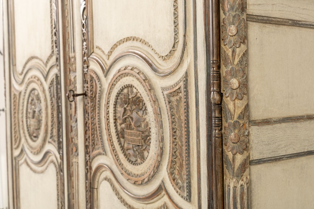 An eighteenth-century carved French painted oak armoire featuring two doors with ornate floral mouldings and short cabriole feet. View VII