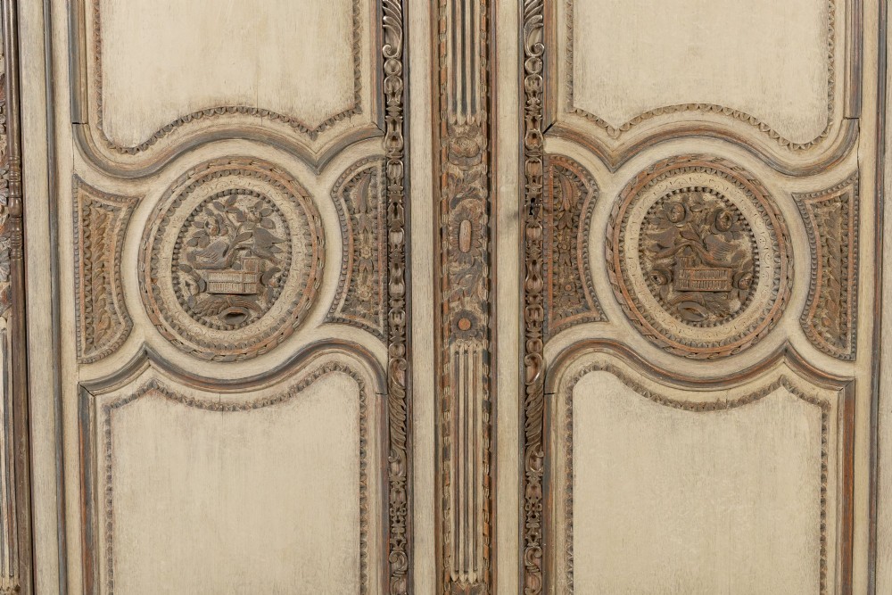 An eighteenth-century carved French painted oak armoire featuring two doors with ornate floral mouldings and short cabriole feet. View X