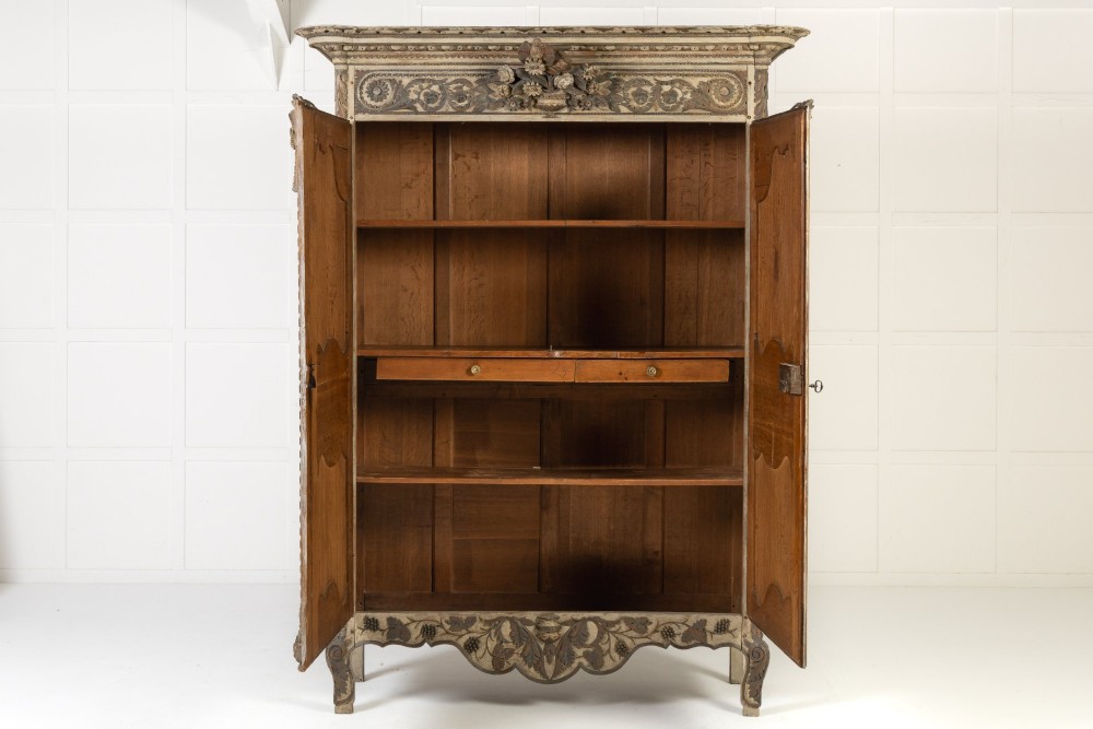 An eighteenth-century carved French painted oak armoire featuring two doors with ornate floral mouldings and short cabriole feet. View XIV