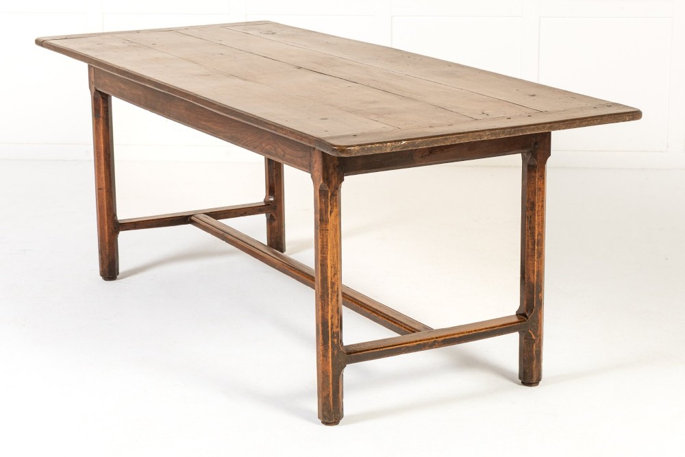 An 18th-century George III oak farmhouse dining table with a rectangular plank top and straight legs joined by low stretchers. View III
