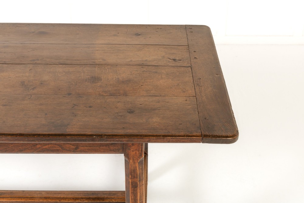 An 18th-century George III oak farmhouse dining table with a rectangular plank top and straight legs joined by low stretchers. View VII