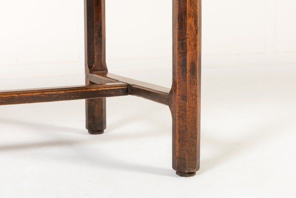 An 18th-century George III oak farmhouse dining table with a rectangular plank top and straight legs joined by low stretchers. View X
