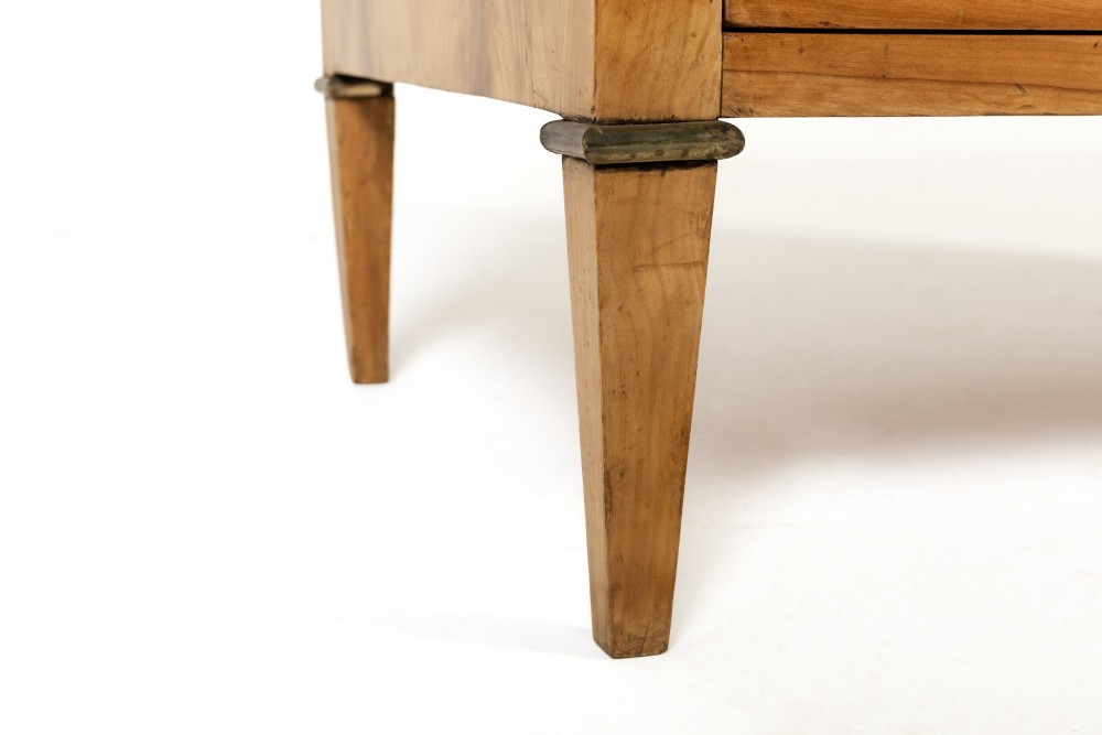 An 18th-century French cherrywood commode featuring three drawers with round brass ring pull handles, an oval keyhole escutcheon, tapered legs, and a grey marble top. View X