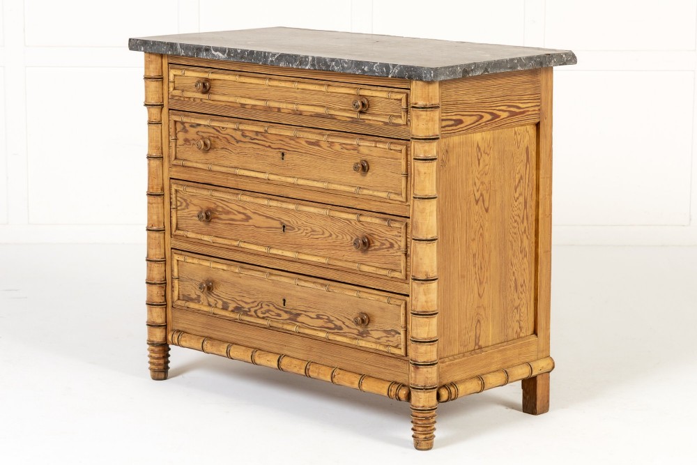 A 19th-century French pine chest of drawers featuring carved faux bamboo borders, four drawers with turned handles, and a grey marble top. View II