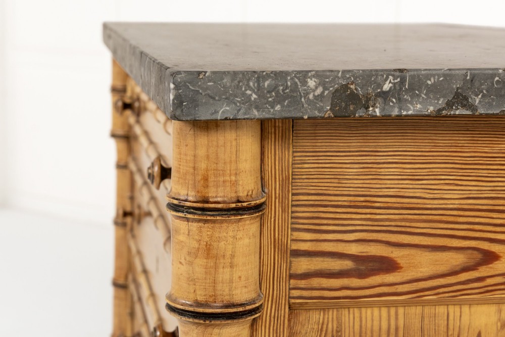 A 19th-century French pine chest of drawers featuring carved faux bamboo borders, four drawers with turned handles, and a grey marble top. View III
