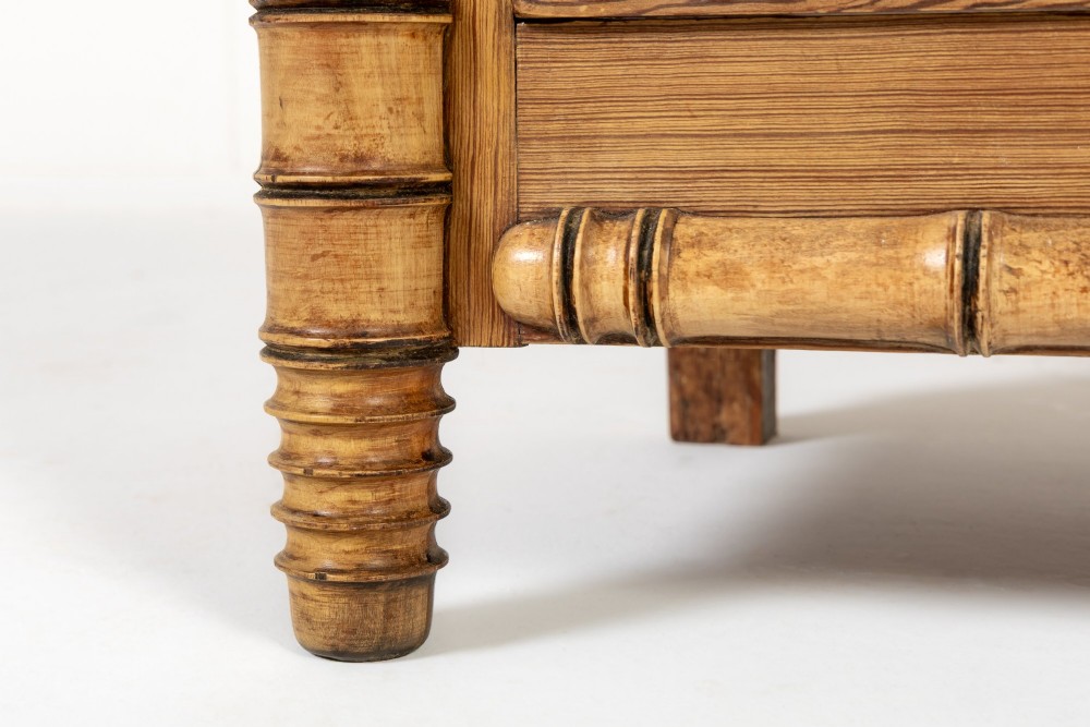 A 19th-century French pine chest of drawers featuring carved faux bamboo borders, four drawers with turned handles, and a grey marble top. View VIII