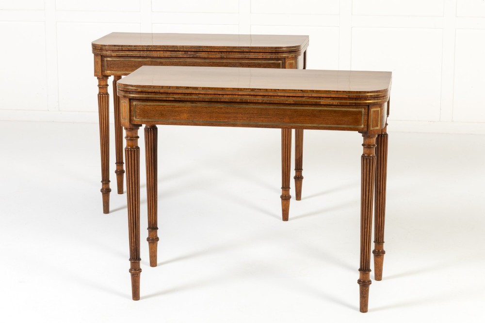 A pair of 19th-century English Regency rosewood foldover card tables with brass stringing inlay and fluted tapered legs. View II