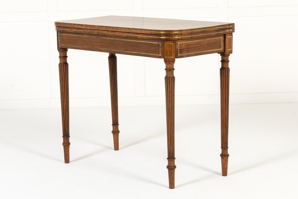 A pair of 19th-century English Regency rosewood foldover card tables with brass stringing inlay and fluted tapered legs. View VIII