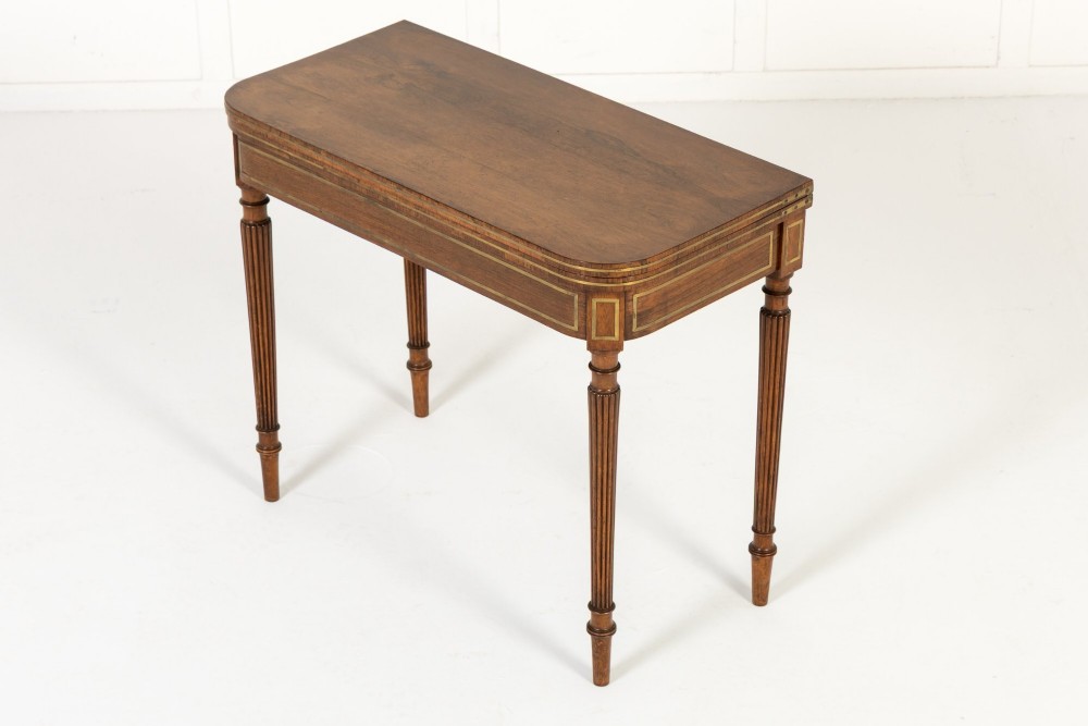 A pair of 19th-century English Regency rosewood foldover card tables with brass stringing inlay and fluted tapered legs. View IX