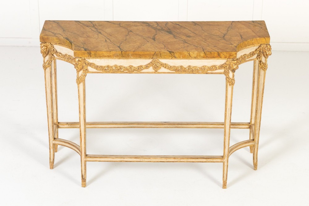 A 19th-century Italian Neoclassical console table featuring a painted cream frame, carved parcel gilt floral swags, tapered legs, and a marble top. View II