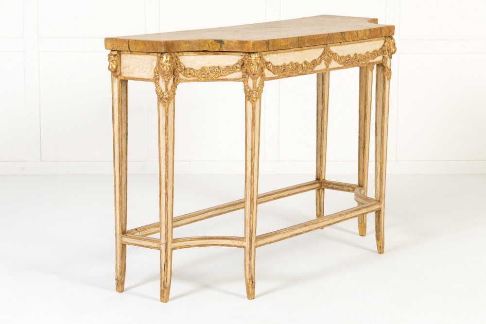 A 19th-century Italian Neoclassical console table featuring a painted cream frame, carved parcel gilt floral swags, tapered legs, and a marble top. View III