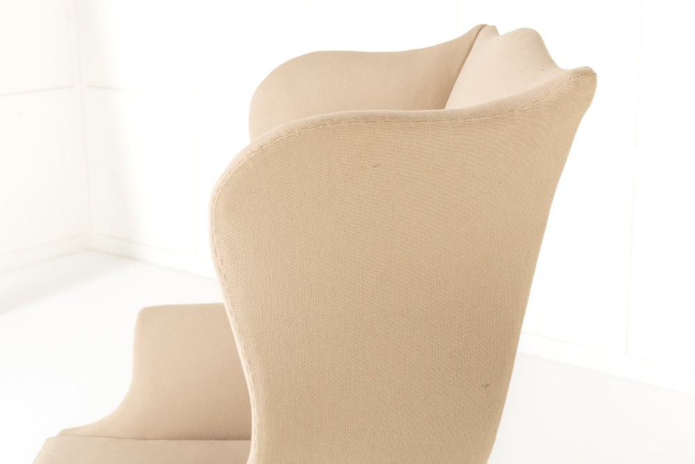An 18th-century mahogany wingback armchair upholstered in neutral beige fabric with square timber legs and brass castors. View IV