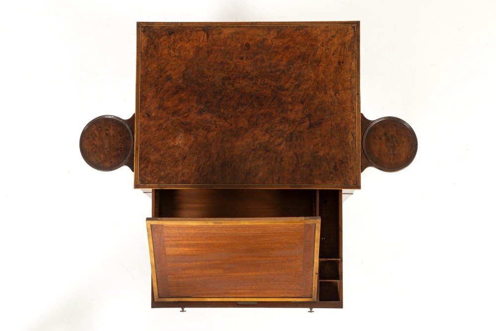 A small 19th-century burr yew wood writing table featuring a single drawer, two pull-out side slides, a lower undershelf, inlaid stringing, tapered legs, and brass casters. View IV