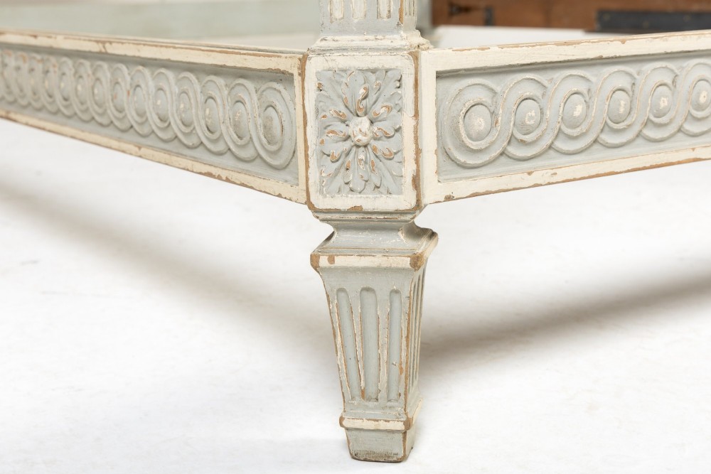 A 19th-century French Neoclassical double bed frame with a light grey painted finish, fluted posts topped with finials, and an arched cream upholstered headboard. View VI