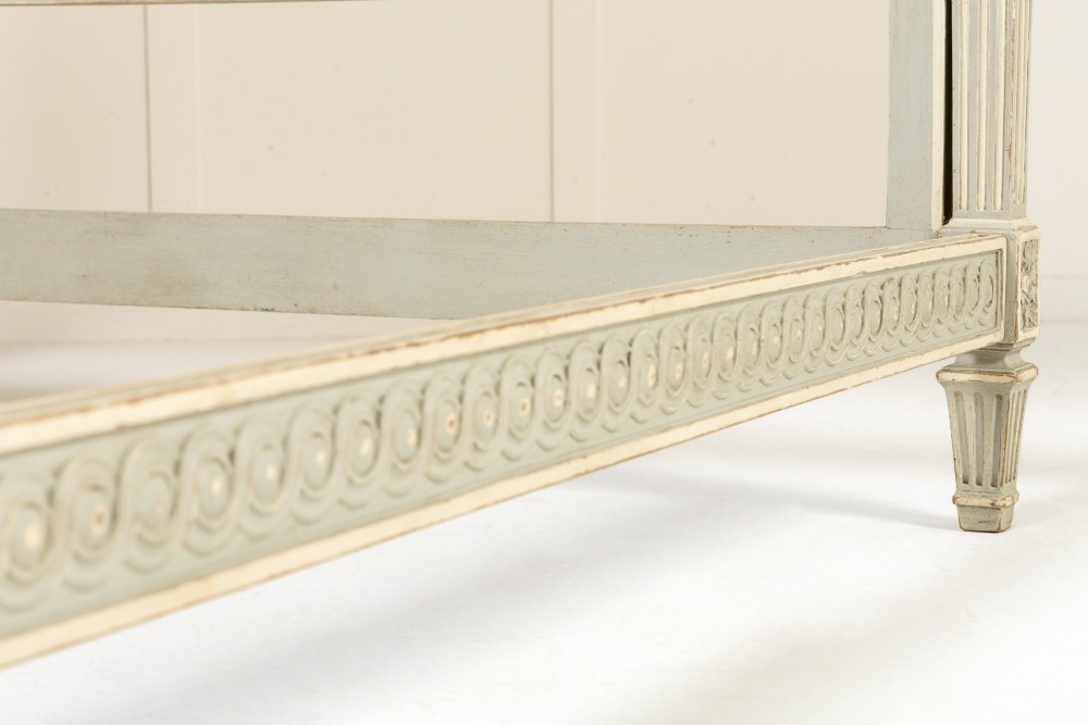 A 19th-century French Neoclassical double bed frame with a light grey painted finish, fluted posts topped with finials, and an arched cream upholstered headboard. View VIII