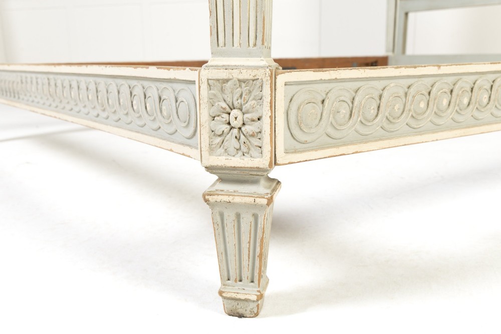 A 19th-century French Neoclassical double bed frame with a light grey painted finish, fluted posts topped with finials, and an arched cream upholstered headboard. View IX