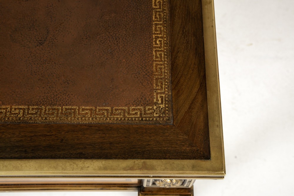 A 19th-century French Louis XVI style bureau plat writing desk featuring geometric parquetry inlay, three frieze drawers, a leather top insert, and brass mounts on square tapered legs. View V
