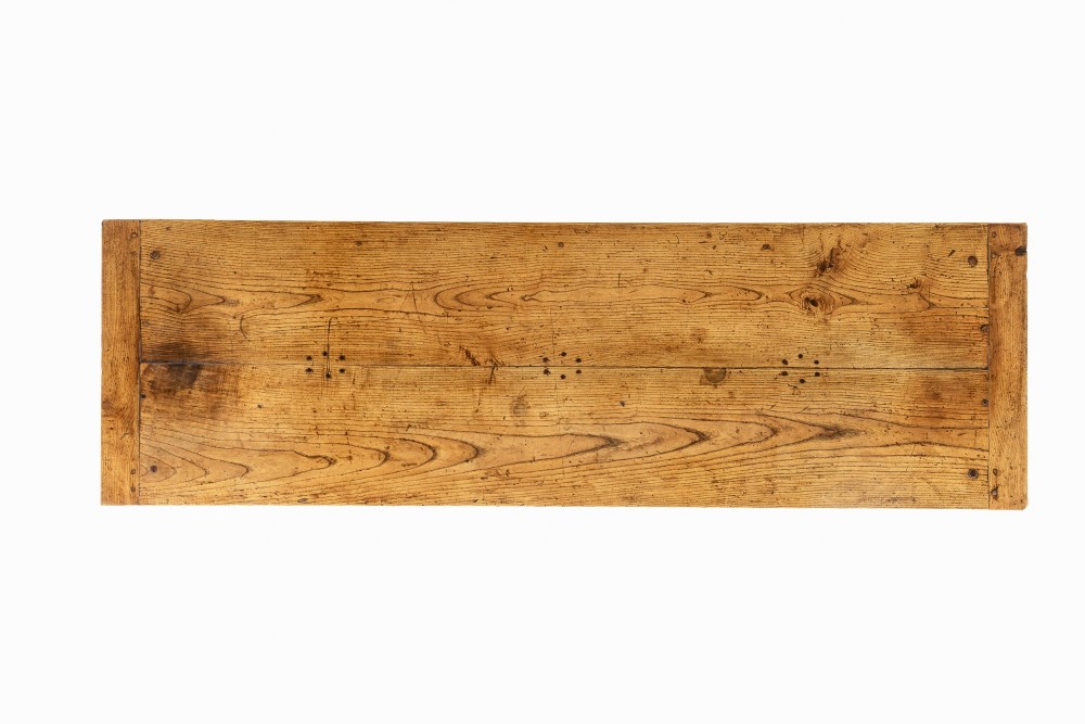 A long, rectangular 18th-century French oak table featuring two drawers with carved recessed pulls and lower stretchers connecting the legs. View VII