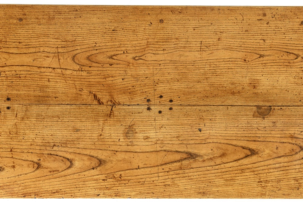 A long, rectangular 18th-century French oak table featuring two drawers with carved recessed pulls and lower stretchers connecting the legs. View VIII