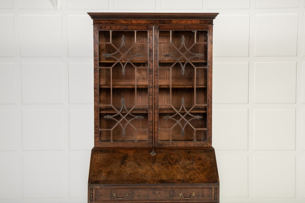 An 18th-century Georgian mahogany bureau bookcase featuring a twin-door upper cabinet with astragal glazing bars over a slant-front writing slope and four graduated drawers on bracket feet. View III