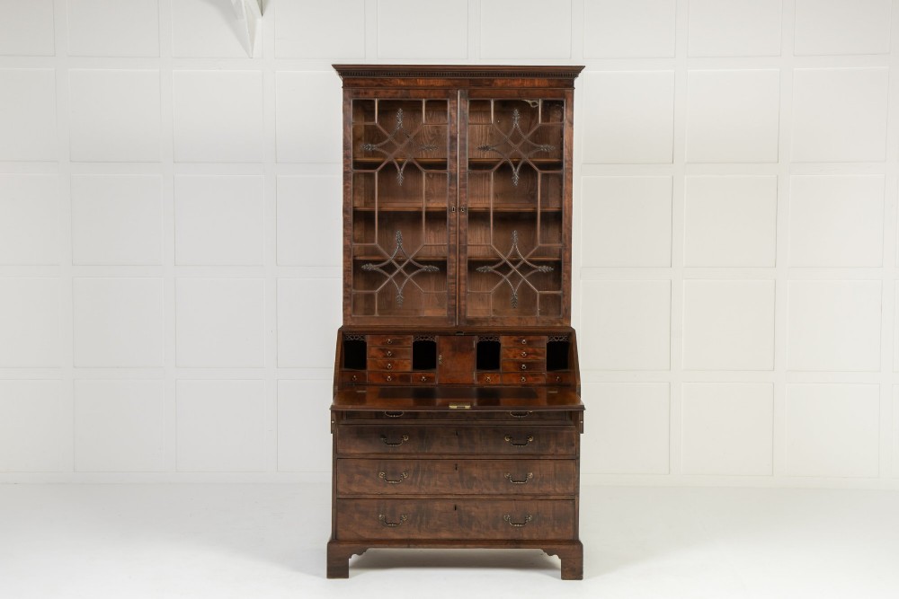 An 18th-century Georgian mahogany bureau bookcase featuring a twin-door upper cabinet with astragal glazing bars over a slant-front writing slope and four graduated drawers on bracket feet. View V