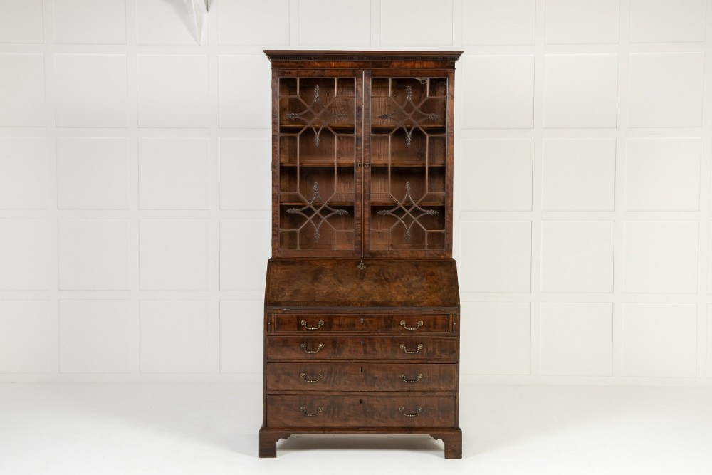 An 18th-century Georgian mahogany bureau bookcase featuring a twin-door upper cabinet with astragal glazing bars over a slant-front writing slope and four graduated drawers on bracket feet. View VI