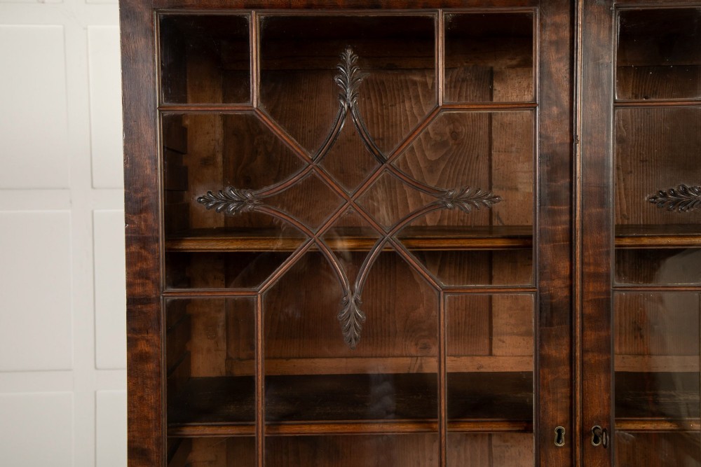 An 18th-century Georgian mahogany bureau bookcase featuring a twin-door upper cabinet with astragal glazing bars over a slant-front writing slope and four graduated drawers on bracket feet. View VII
