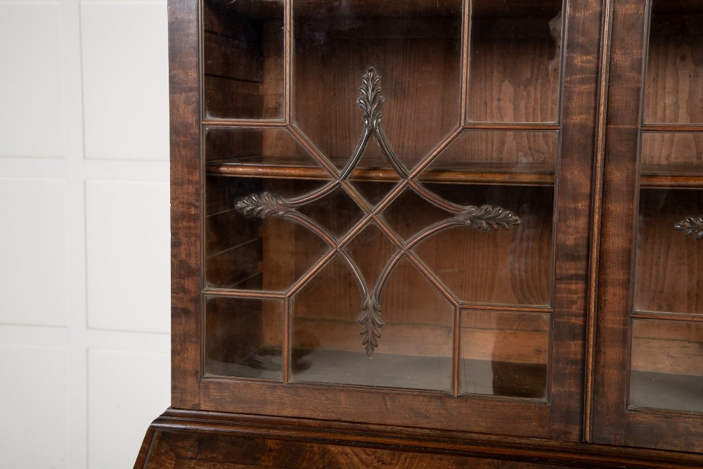 An 18th-century Georgian mahogany bureau bookcase featuring a twin-door upper cabinet with astragal glazing bars over a slant-front writing slope and four graduated drawers on bracket feet. View VIII