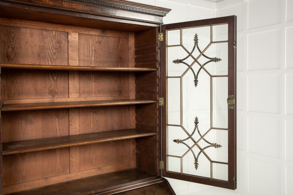 An 18th-century Georgian mahogany bureau bookcase featuring a twin-door upper cabinet with astragal glazing bars over a slant-front writing slope and four graduated drawers on bracket feet. View XII