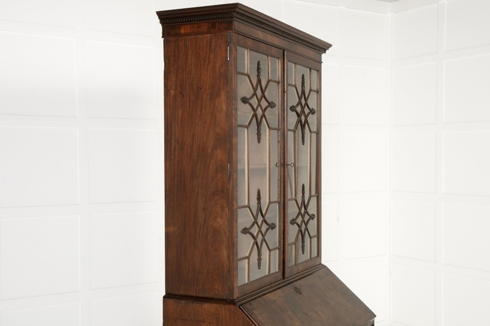 An 18th-century Georgian mahogany bureau bookcase featuring a twin-door upper cabinet with astragal glazing bars over a slant-front writing slope and four graduated drawers on bracket feet. View XIII