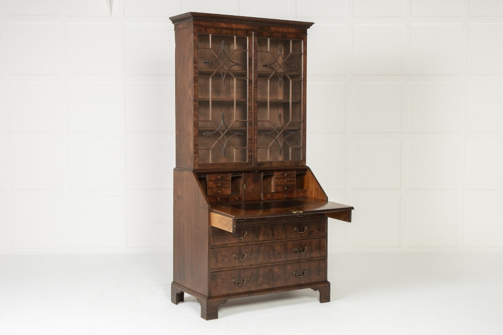 An 18th-century Georgian mahogany bureau bookcase featuring a twin-door upper cabinet with astragal glazing bars over a slant-front writing slope and four graduated drawers on bracket feet. View XIV