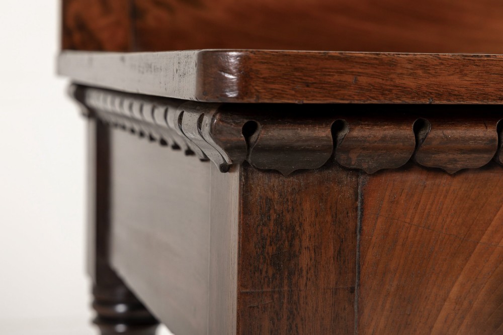 A 19th-century Regency mahogany serving table featuring a pointed splashback upstand, decorative carved frieze, turned front legs, and carved lion paw feet. View III