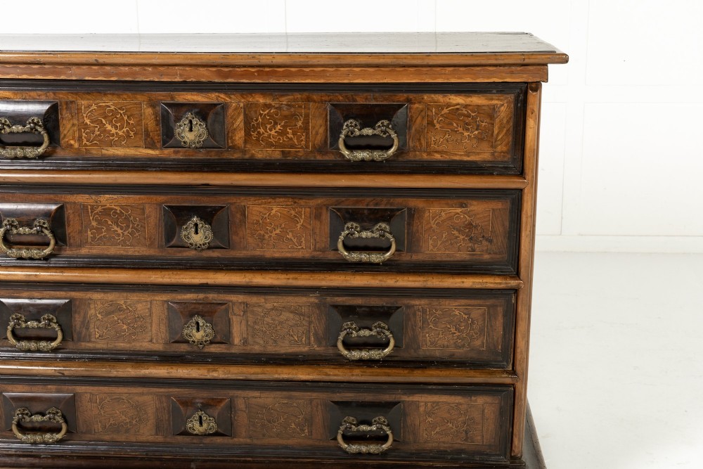 An 18th-century Italian walnut chest of drawers featuring foliage marquetry, brass drop handles, and geometric side moulding. View III