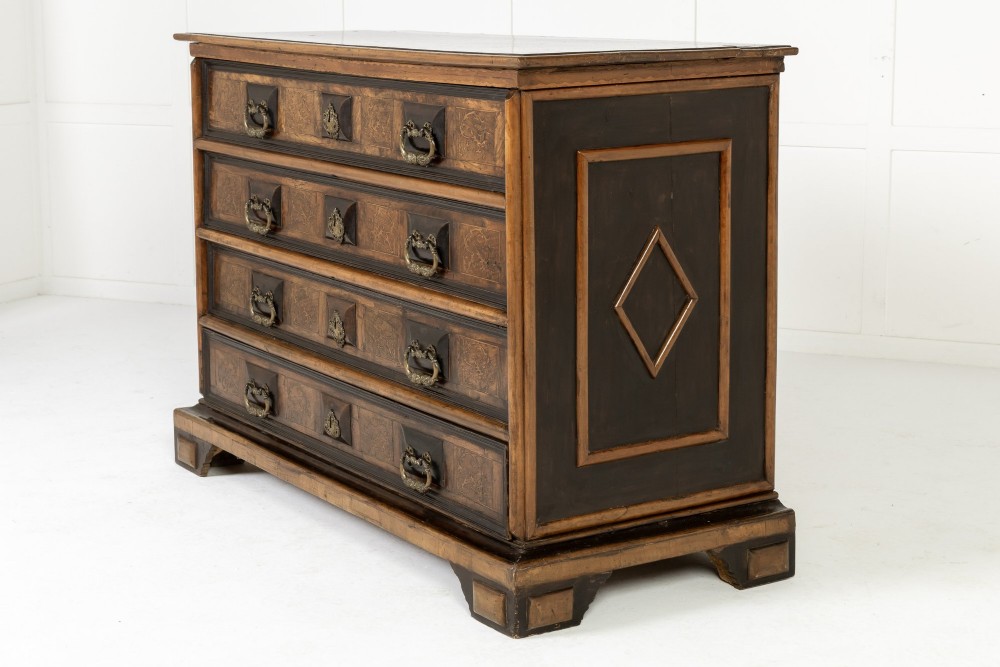 An 18th-century Italian walnut chest of drawers featuring foliage marquetry, brass drop handles, and geometric side moulding. View VII