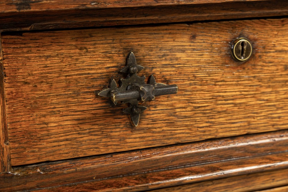 A large 19th-century English oak partners desk with twin pedestals, multiple drawers, metal drop handles, and panelled sides. View V