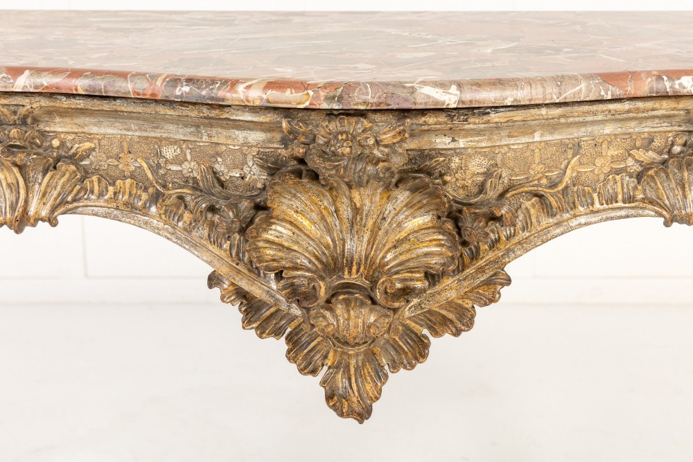 An 18th-century Italian Rococo console table featuring carved silver gilt legs with central shell motifs and a contoured variegated marble top. View II