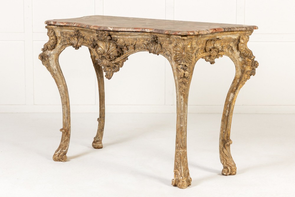An 18th-century Italian Rococo console table featuring carved silver gilt legs with central shell motifs and a contoured variegated marble top. View XI