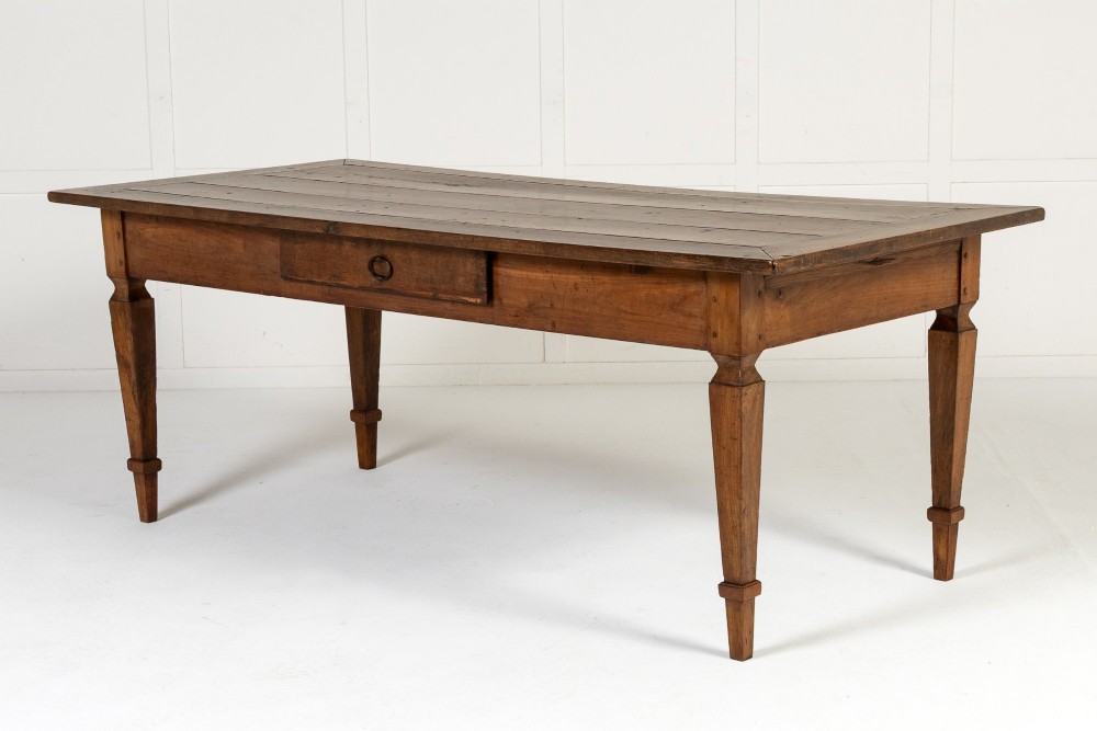 An 18th-century French cherrywood rectangular farmhouse dining table featuring a framed plank top, frieze drawer, and tapered legs. View V