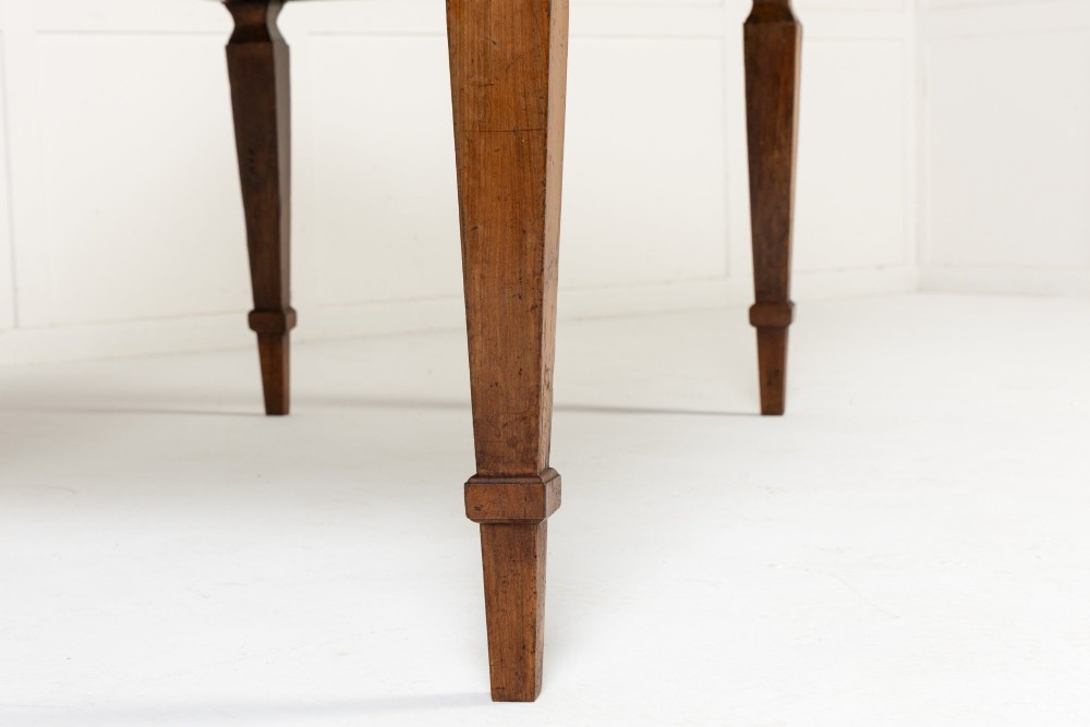 An 18th-century French cherrywood rectangular farmhouse dining table featuring a framed plank top, frieze drawer, and tapered legs. View VI