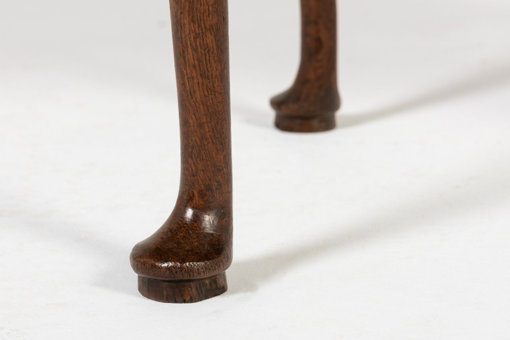 An 18th-century dark oak lowboy table featuring three drawers with brass handles, a shaped apron, and cabriole legs terminating in pad feet. View VIII