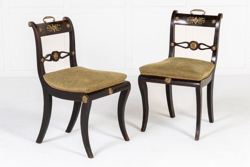 A set of six early nineteenth-century Regency dining chairs crafted from dark wood with brass inlay detailing, brass top handles, and green upholstered seats. View III