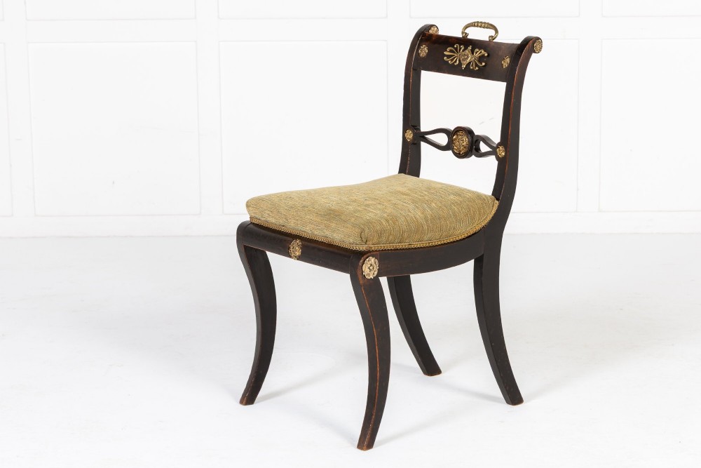 A set of six early nineteenth-century Regency dining chairs crafted from dark wood with brass inlay detailing, brass top handles, and green upholstered seats. View IV