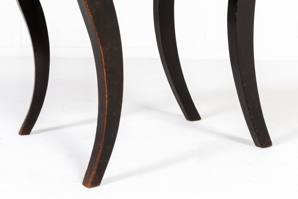 A set of six early nineteenth-century Regency dining chairs crafted from dark wood with brass inlay detailing, brass top handles, and green upholstered seats. View VI